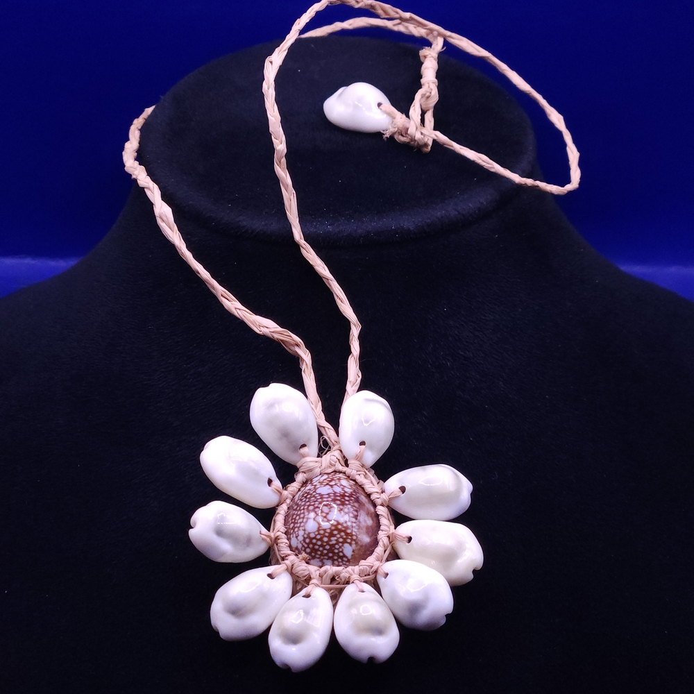 handmade Hawaiian-style necklace featuring a large, patterned shell centerpiece